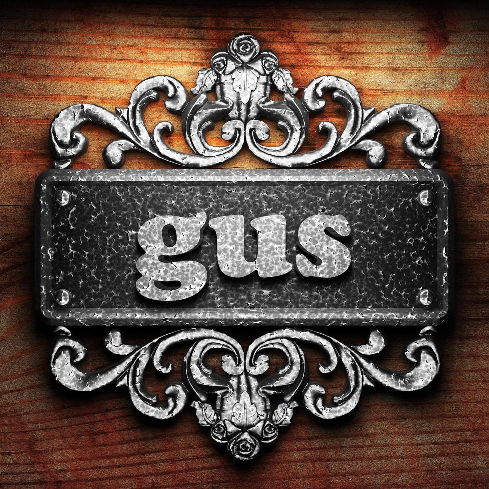 gus word of iron on wooden background photo