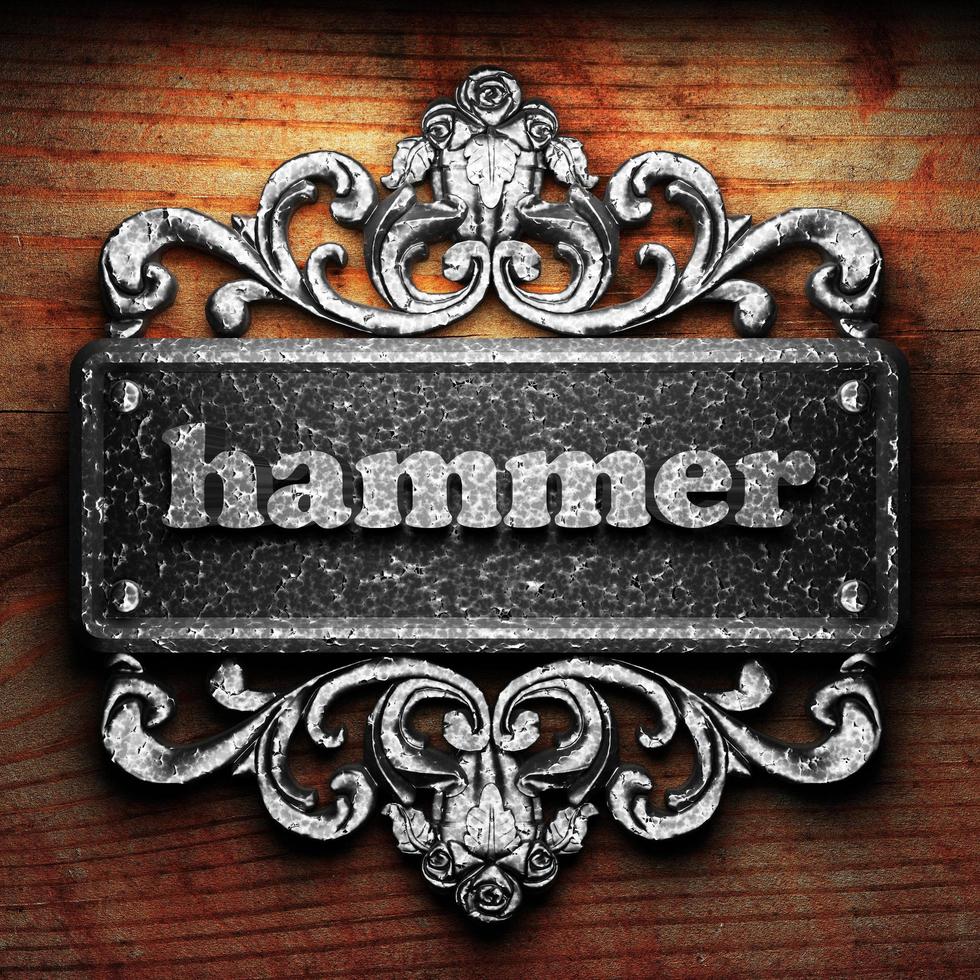 hammer word of iron on wooden background photo