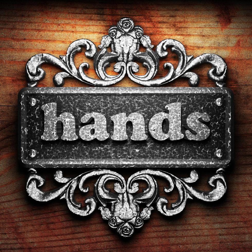 hands word of iron on wooden background photo