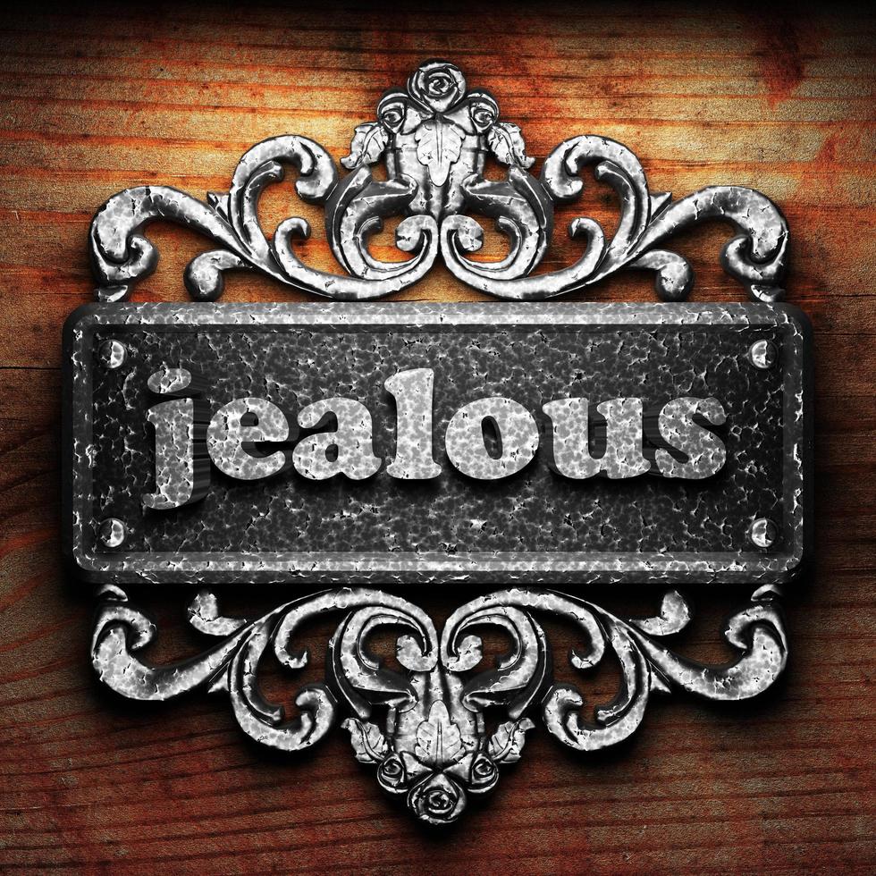 jealous word of iron on wooden background photo