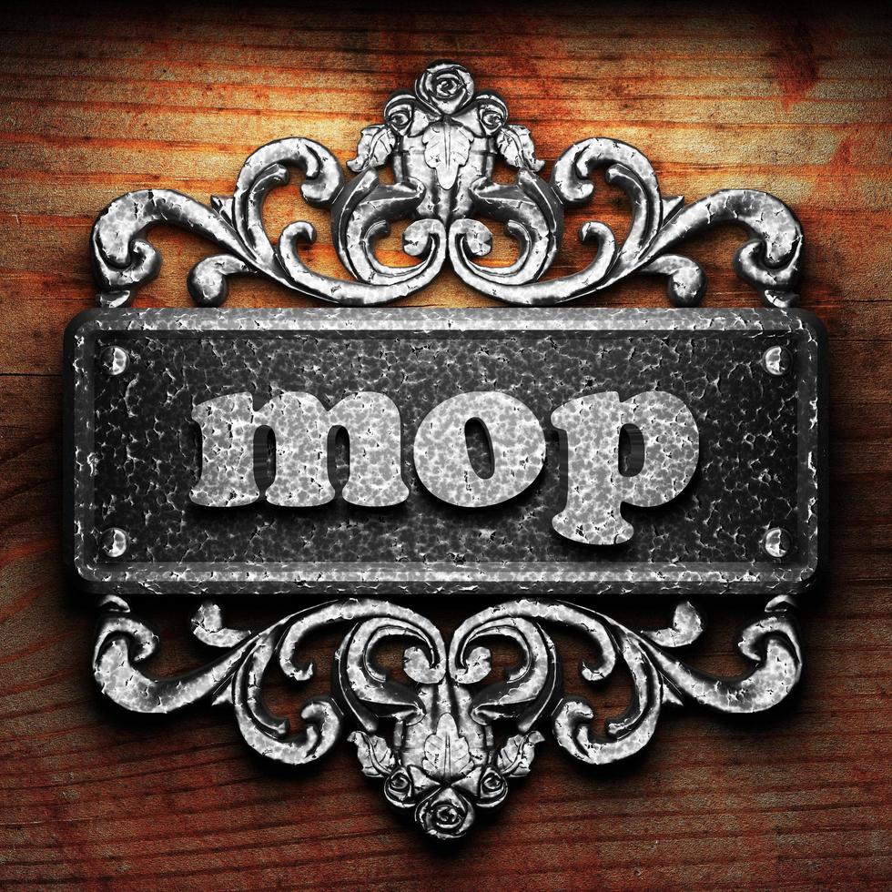 mop word of iron on wooden background photo