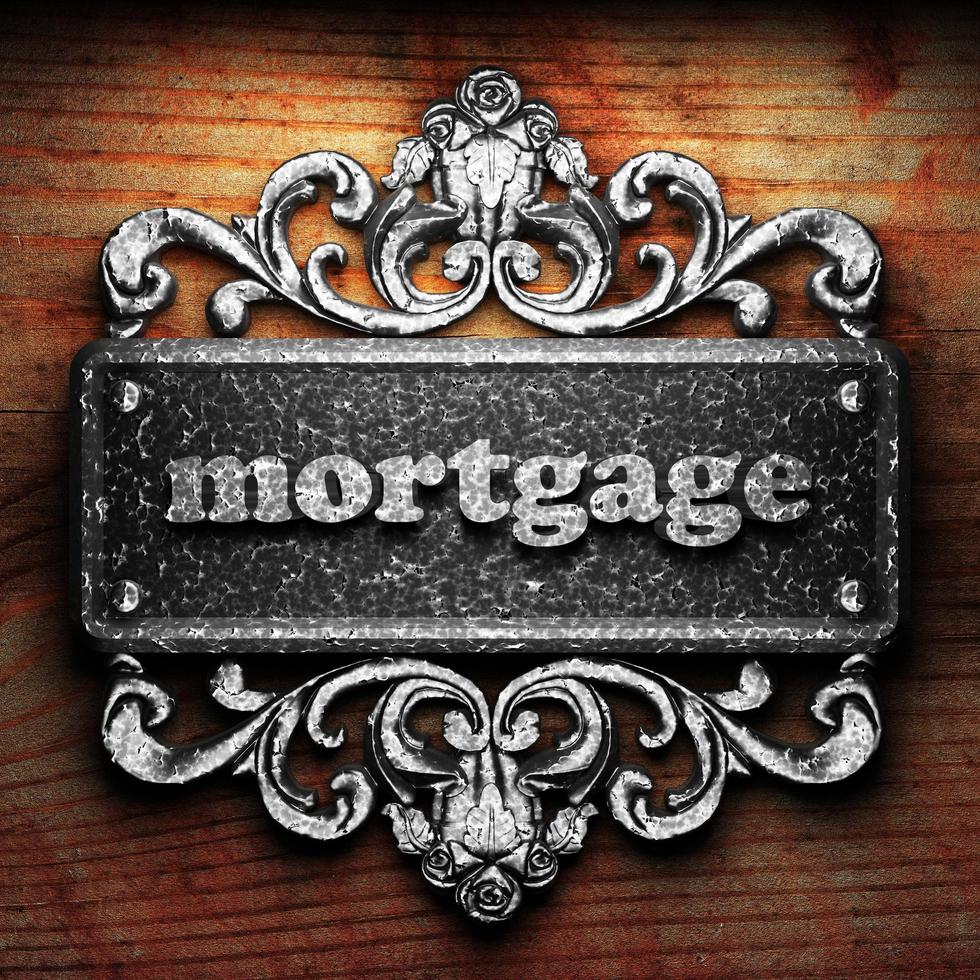 mortgage word of iron on wooden background photo