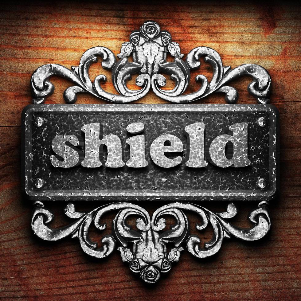 shield word of iron on wooden background photo
