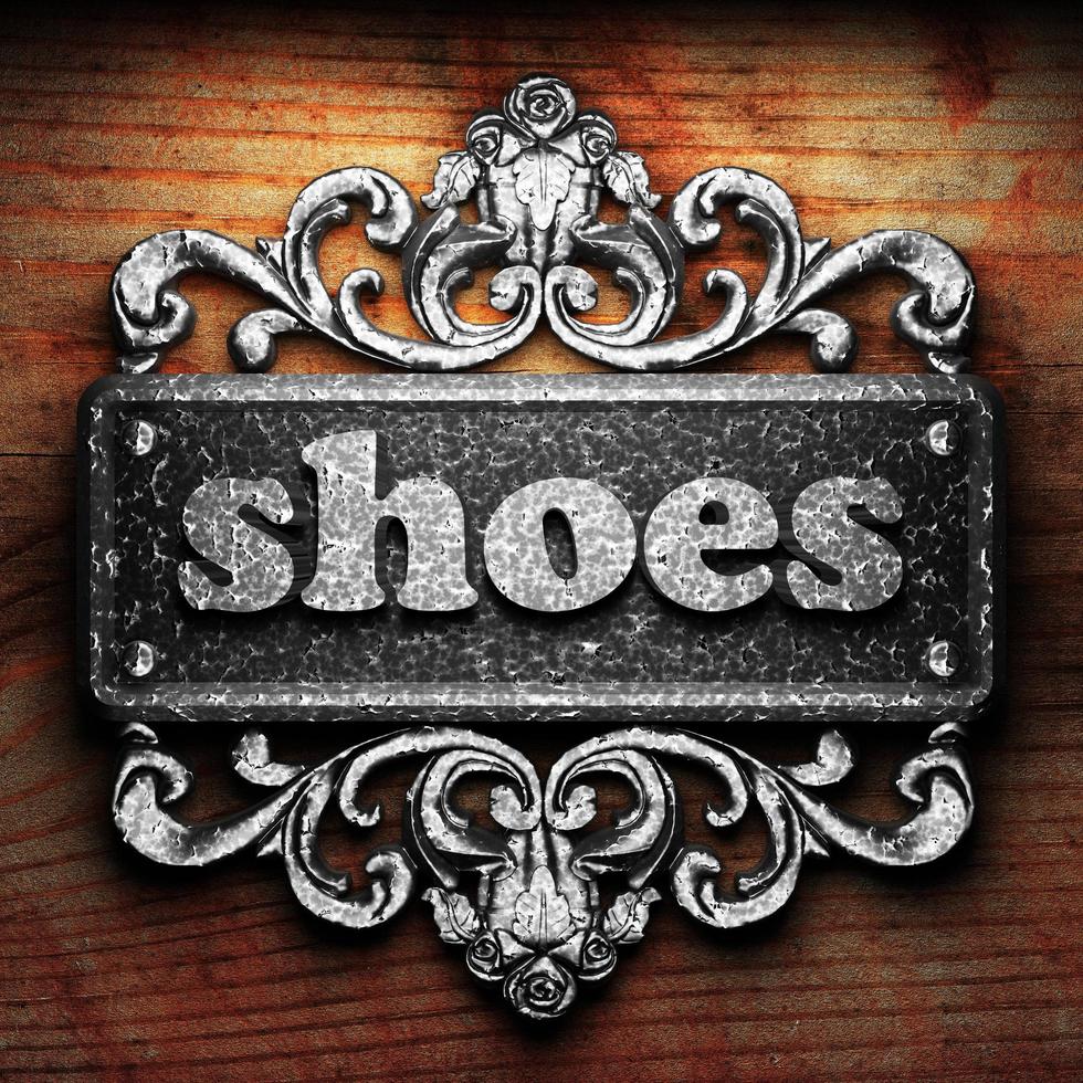 shoes word of iron on wooden background photo