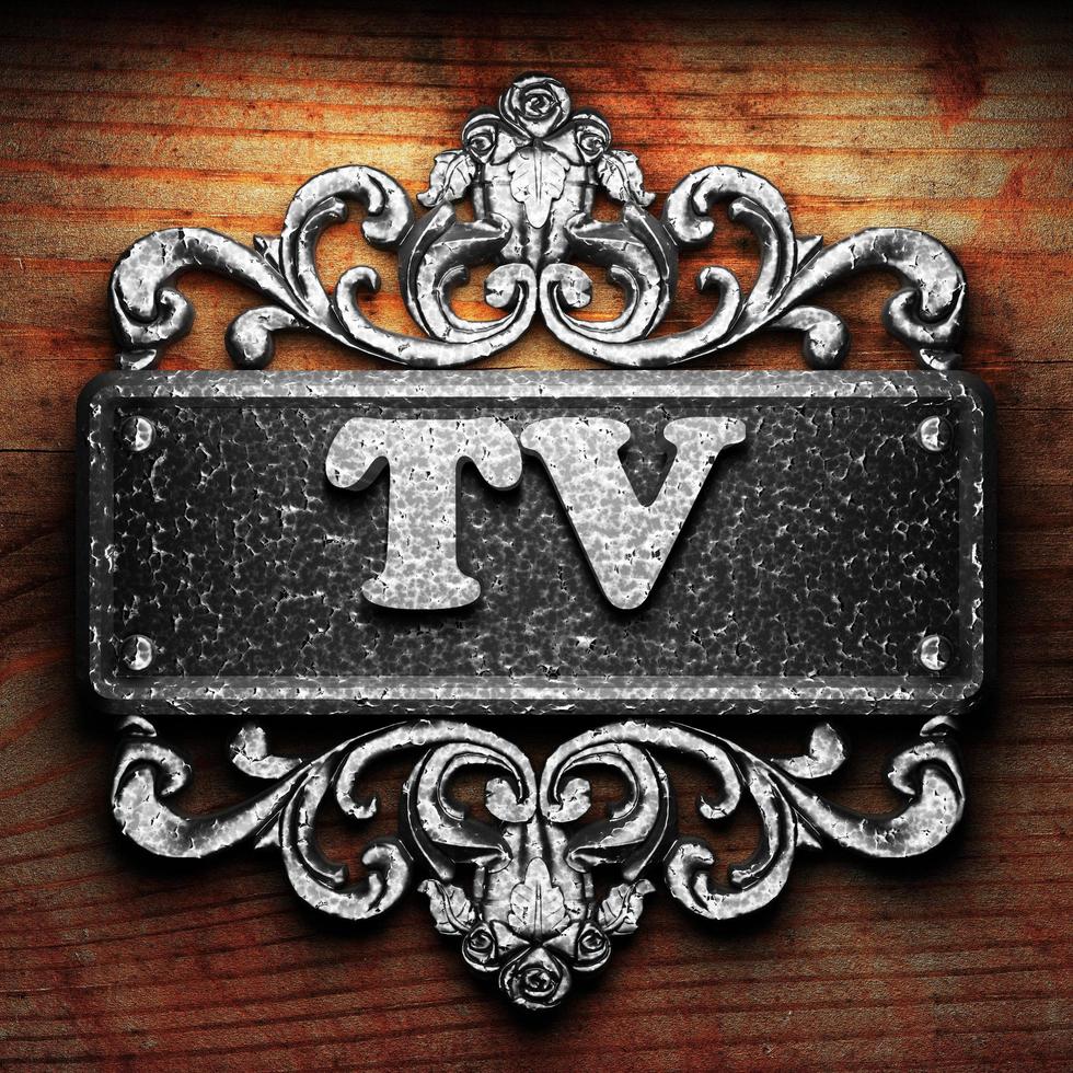 TV word of iron on wooden background photo