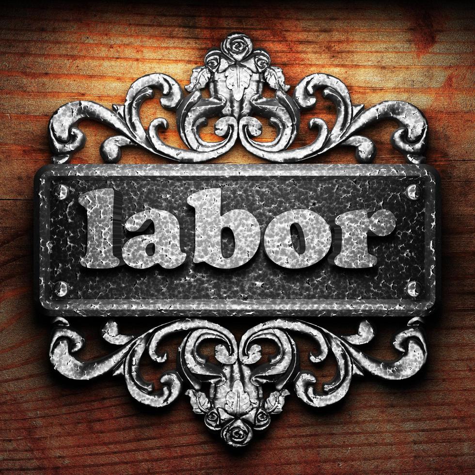 labor word of iron on wooden background photo