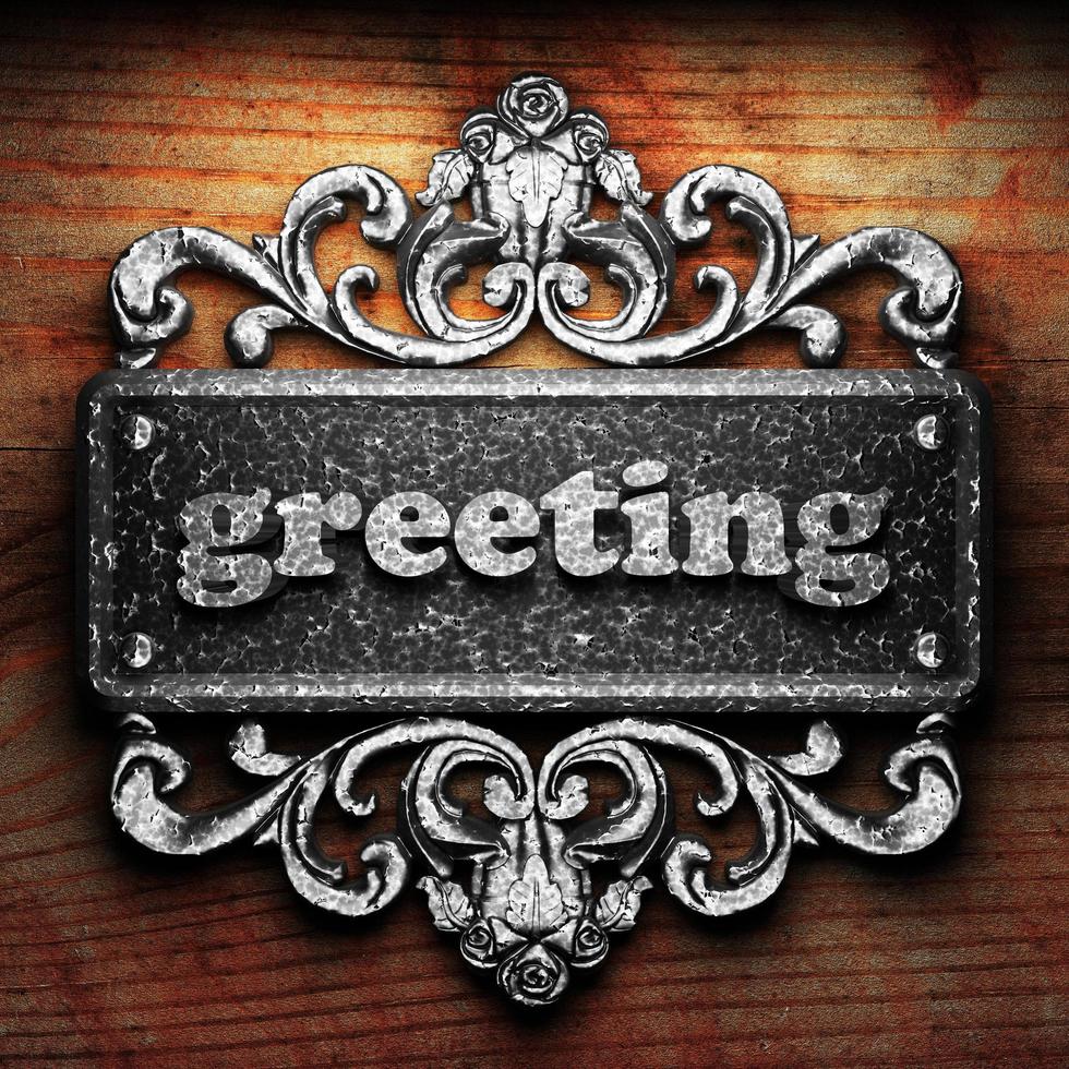 greeting word of iron on wooden background photo