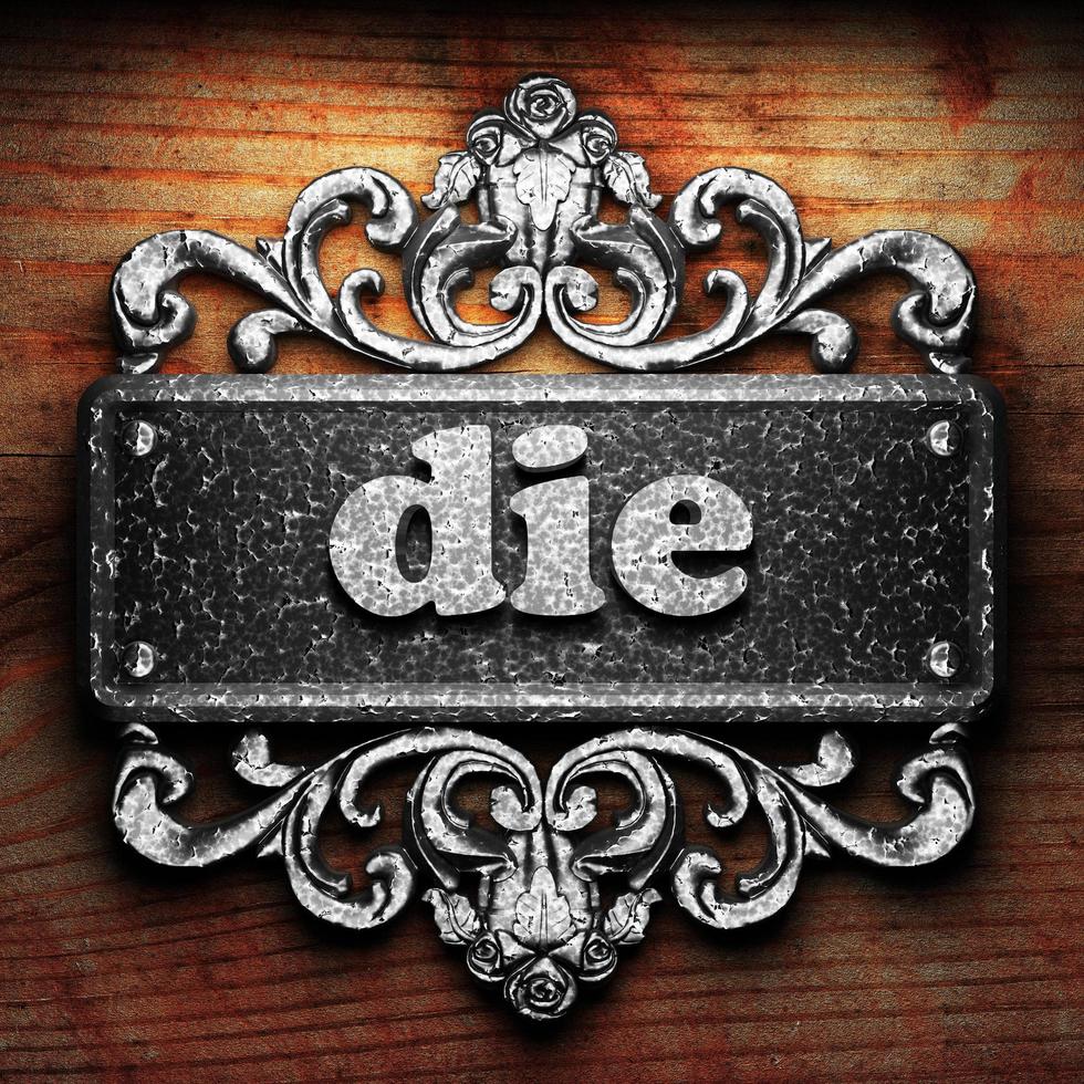 die word of iron on wooden background photo