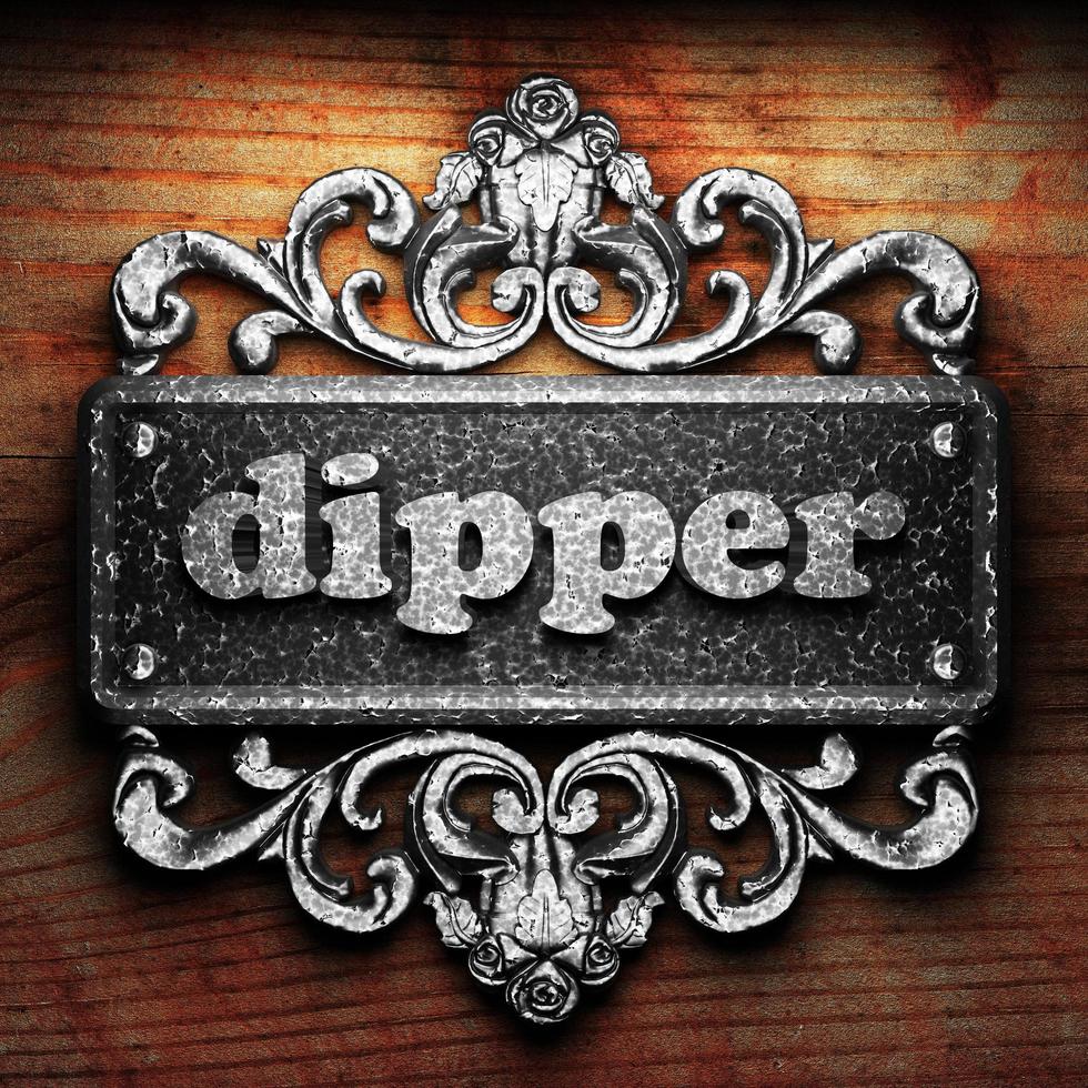 dipper word of iron on wooden background photo