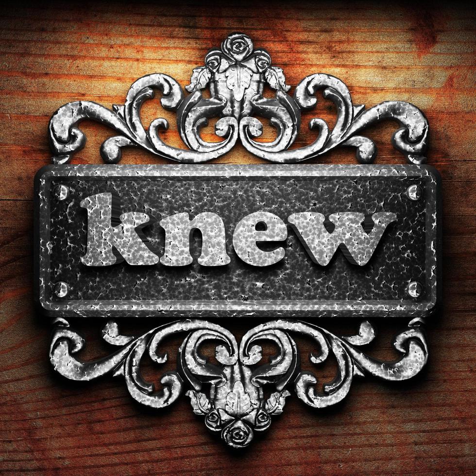 knew word of iron on wooden background photo