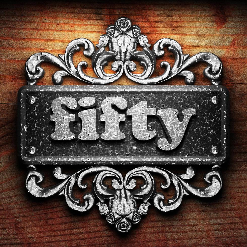 fifty word of iron on wooden background photo
