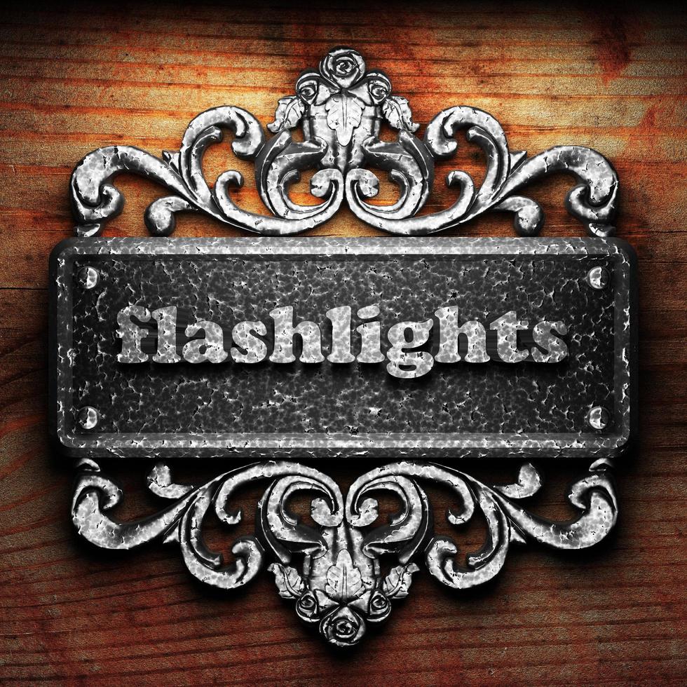flashlights word of iron on wooden background photo