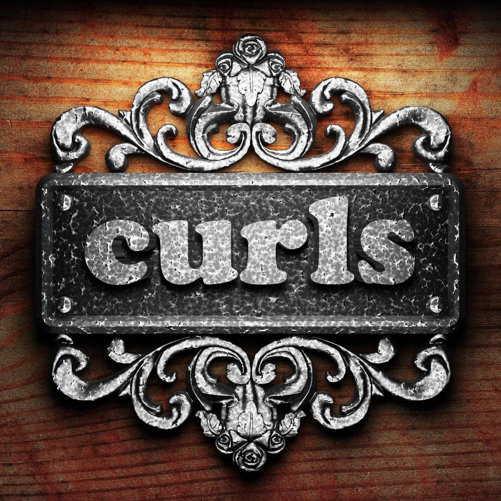 curls word of iron on wooden background photo