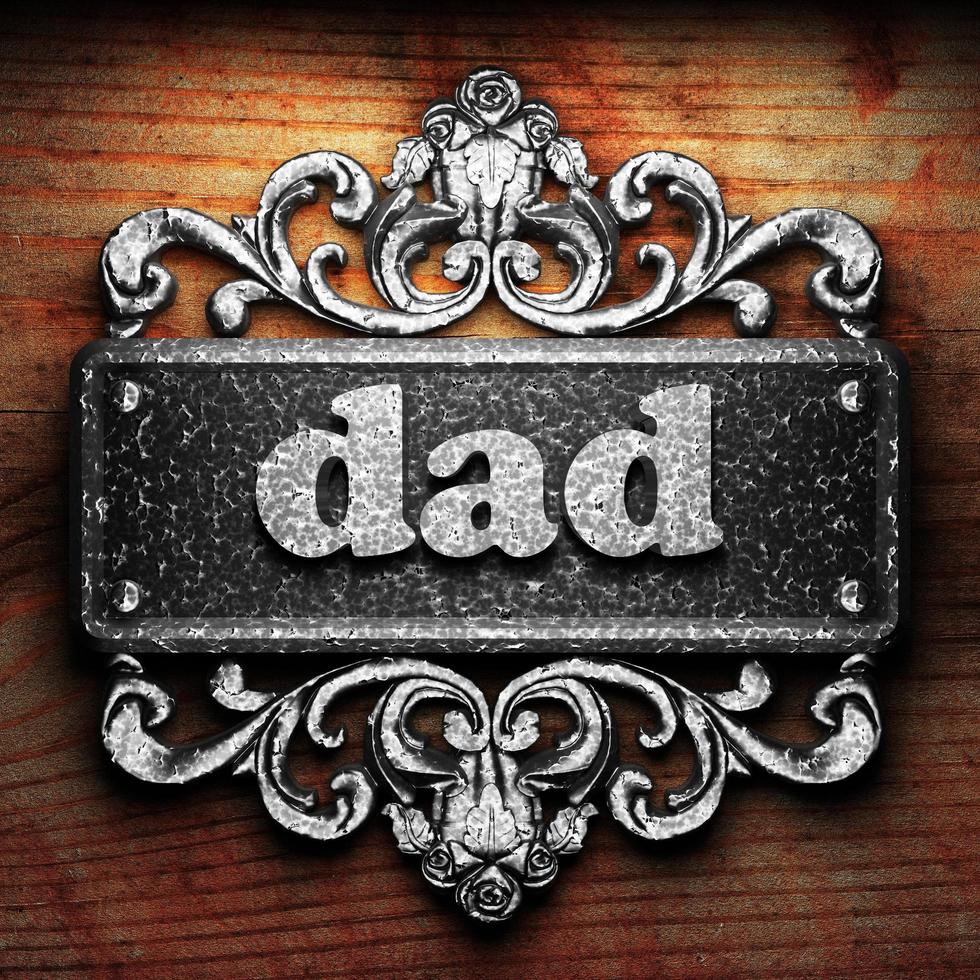 dad word of iron on wooden background photo