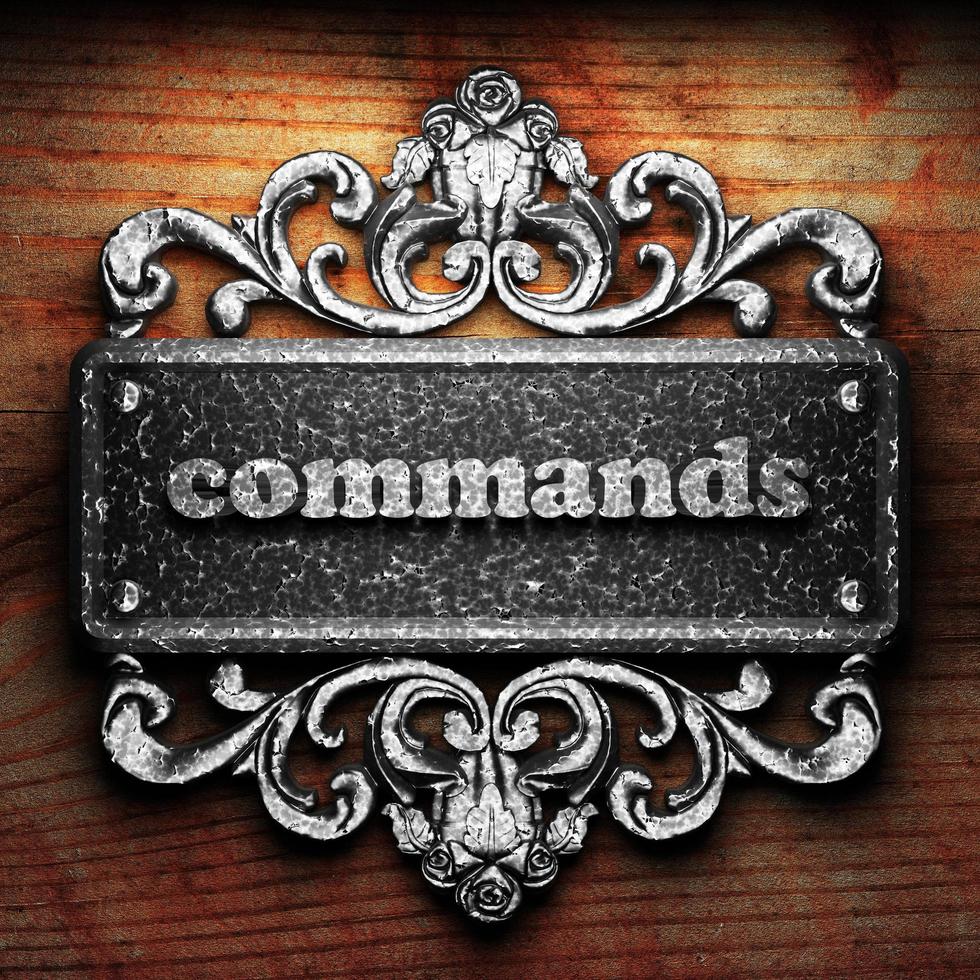 commands word of iron on wooden background photo