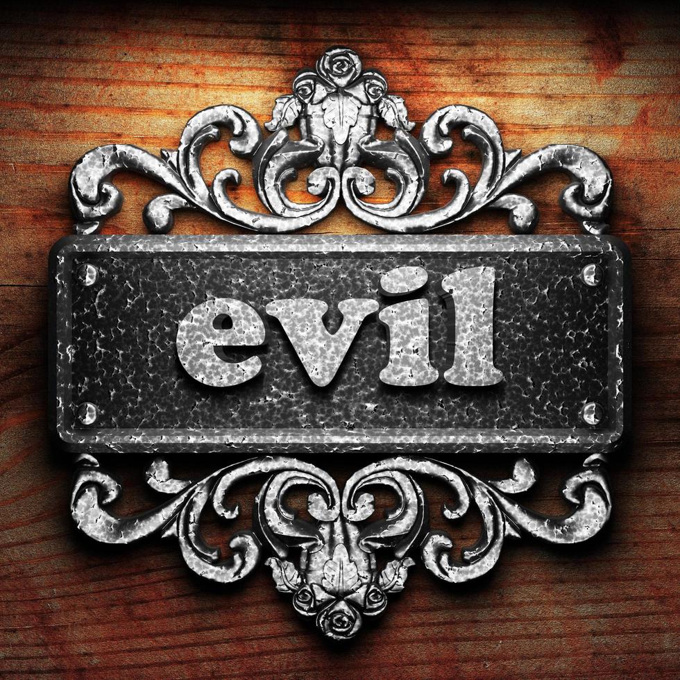 evil word of iron on wooden background photo