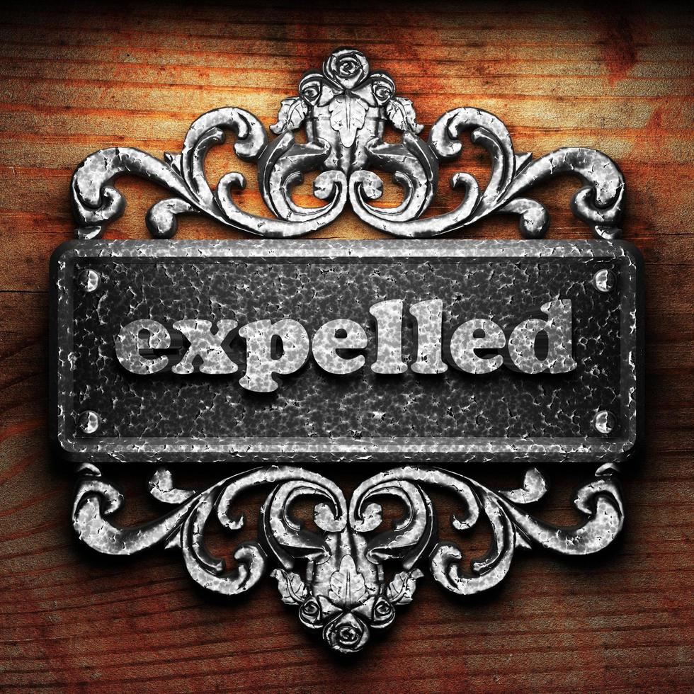 expelled word of iron on wooden background photo