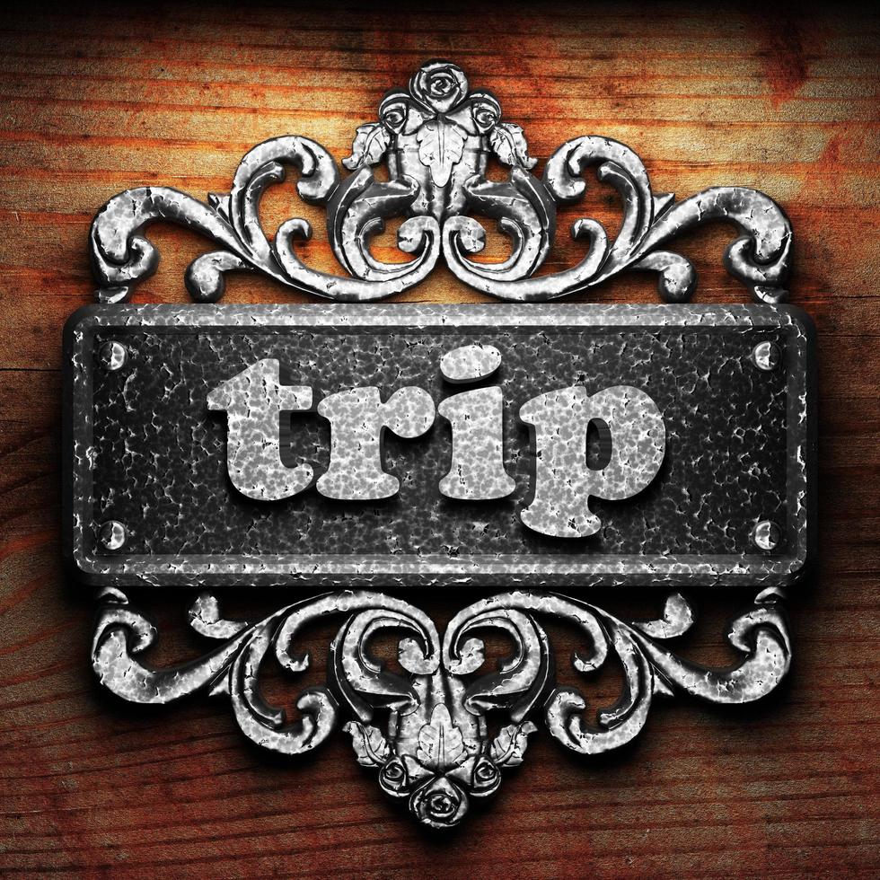 trip word of iron on wooden background photo