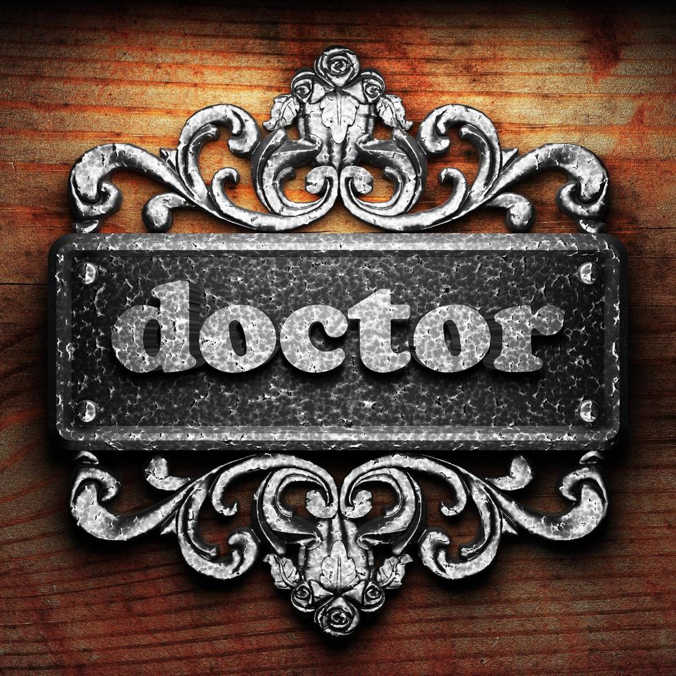 doctor word of iron on wooden background photo