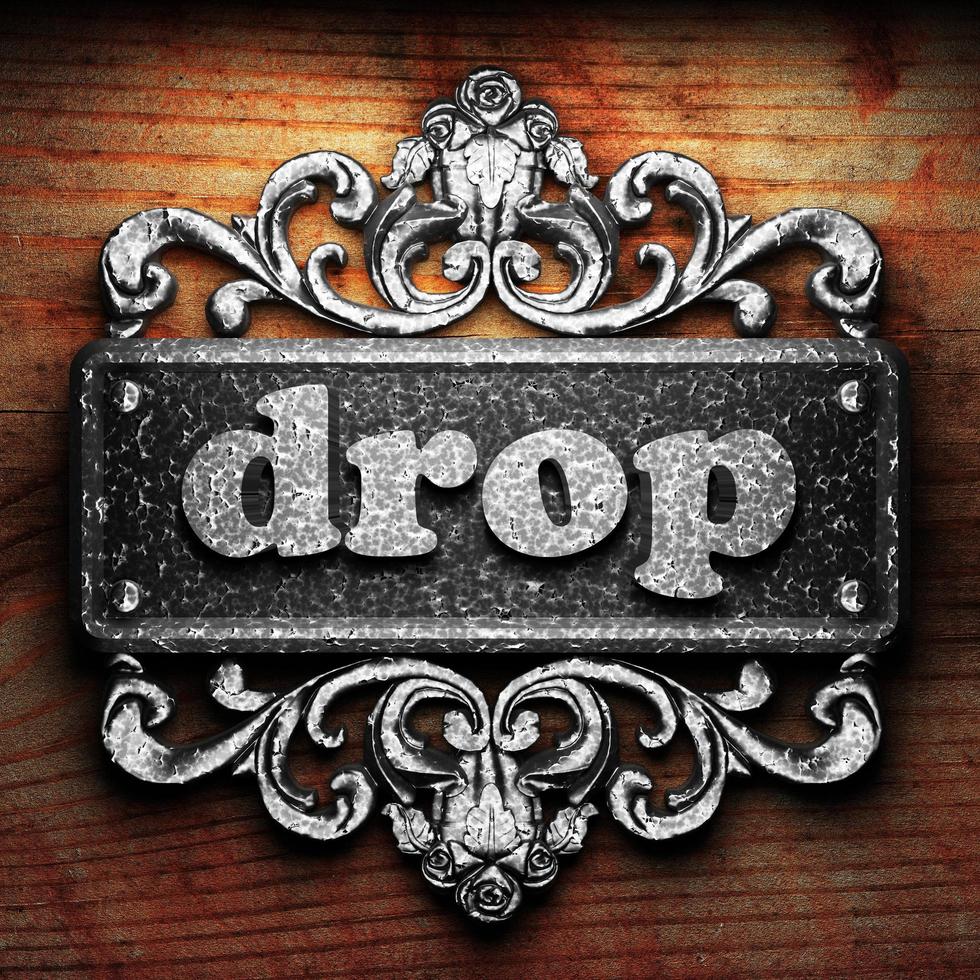 drop word of iron on wooden background photo