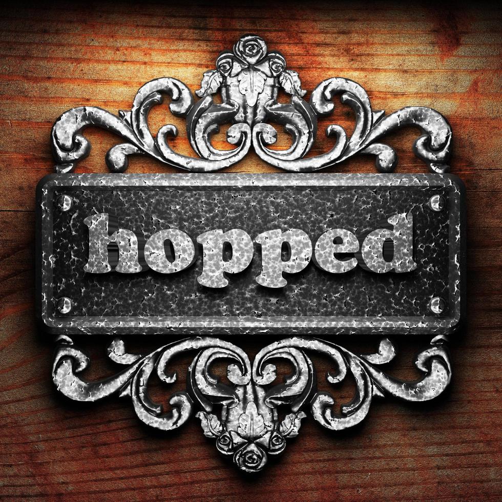 hopped word of iron on wooden background photo