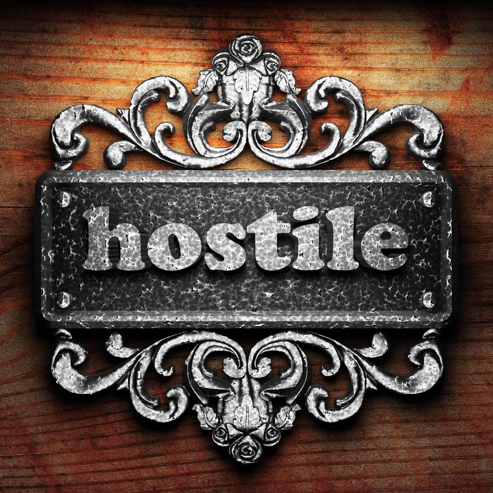 hostile word of iron on wooden background photo