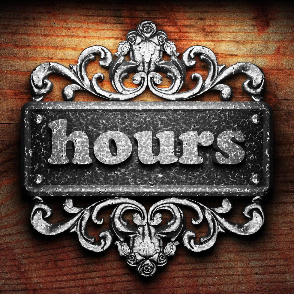 hours word of iron on wooden background photo