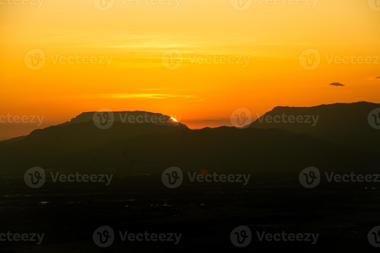 The sun was setting on the edge of the ridge Mountain. sunset photo