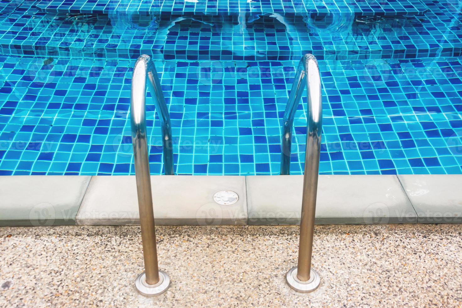 stair of swimming pool with blue water photo