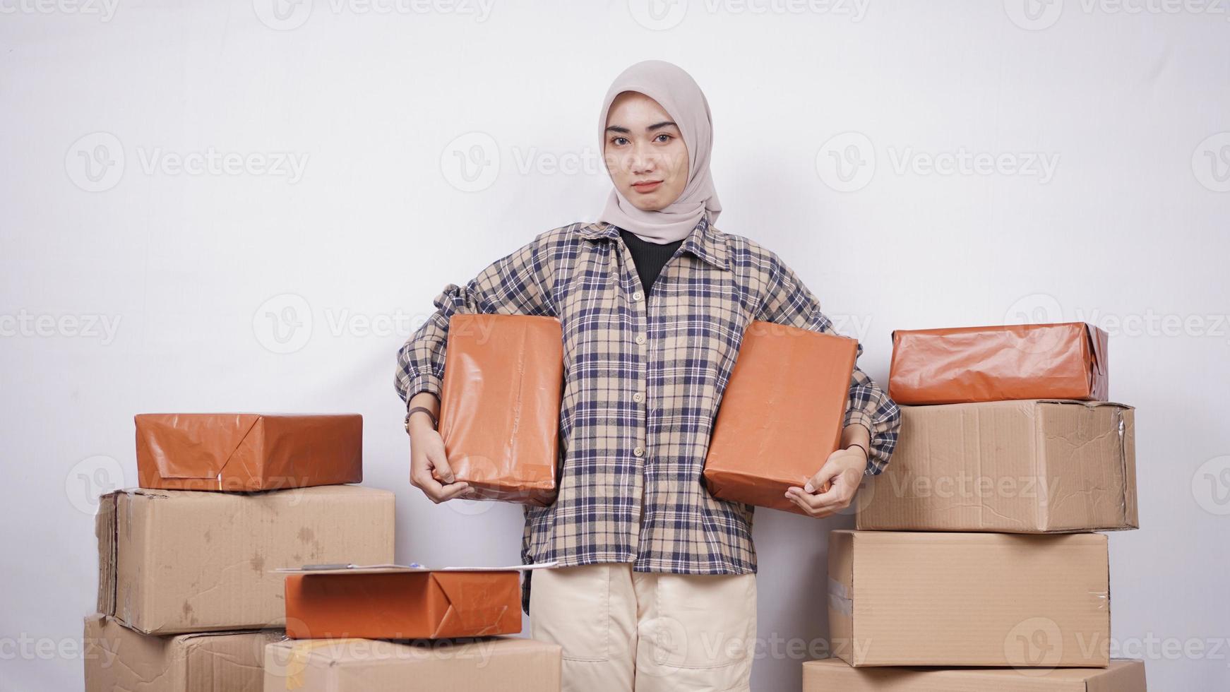 Beautiful asian businesswoman showing packages happily isolated on white background photo