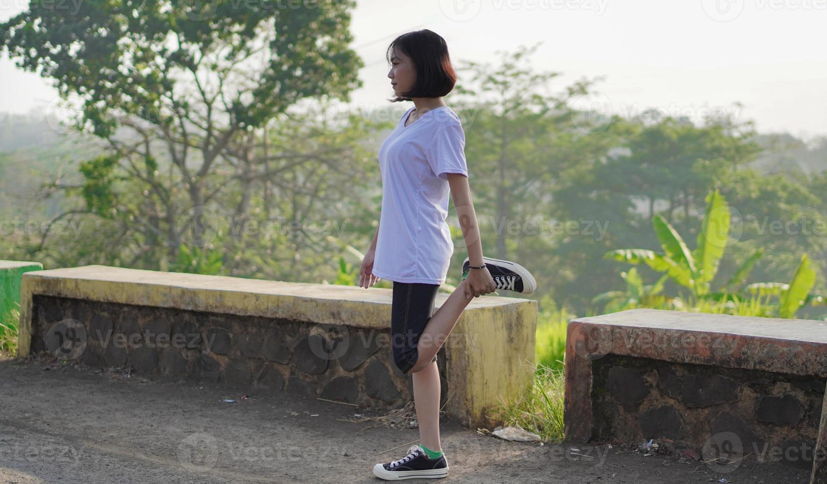 Young Asian woman has  streaching before doing jogging and running in the morning photo
