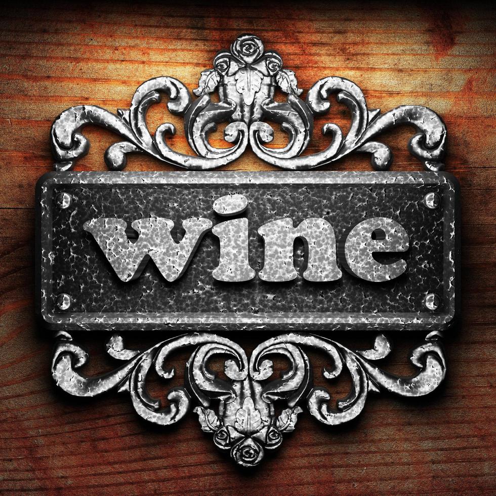 wine word of iron on wooden background photo