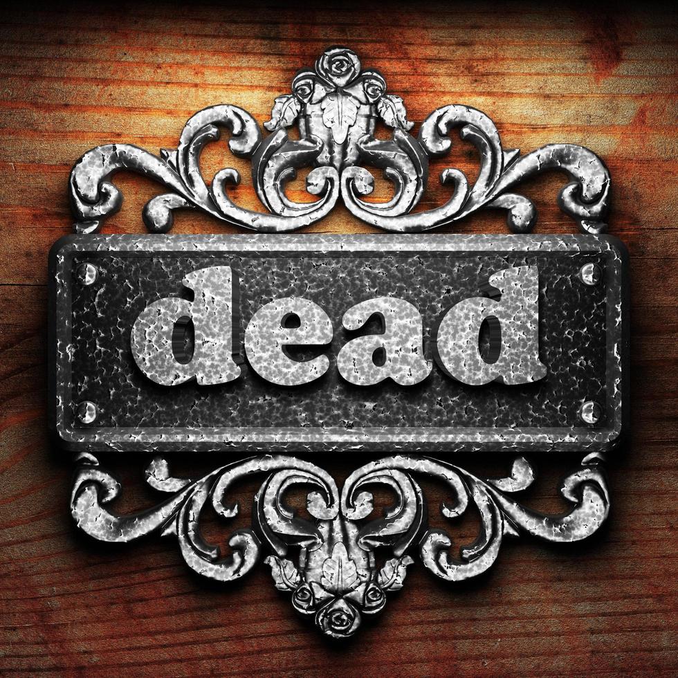 dead word of iron on wooden background photo