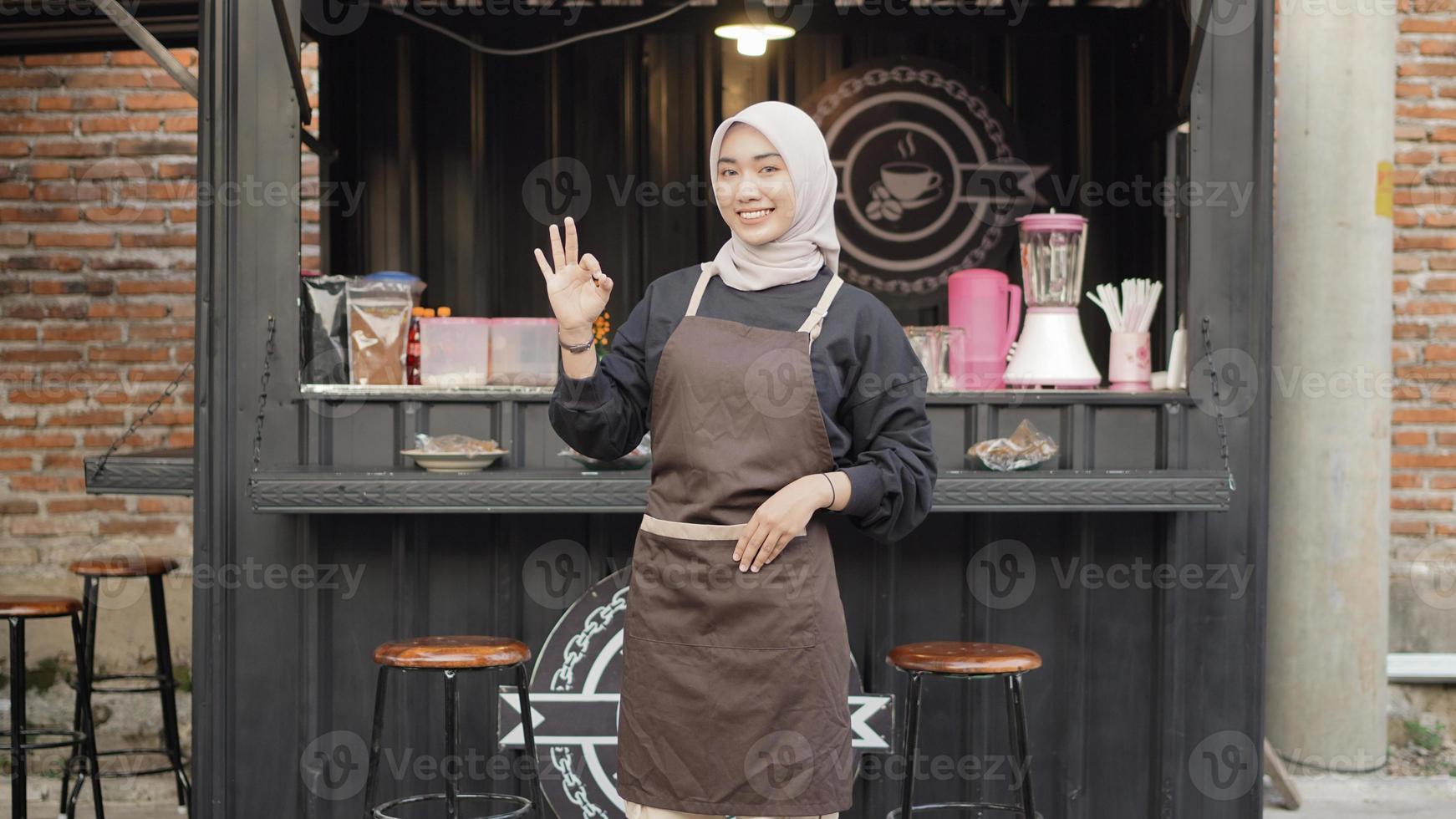 beautiful smiling waitress ready to open cafe booth container photo