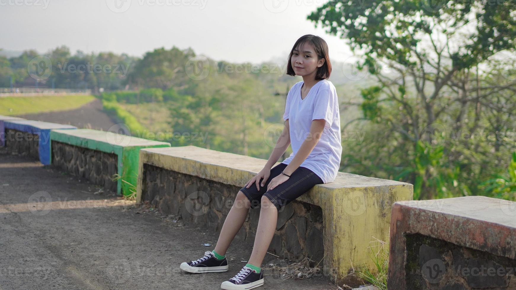 young asian woman resting after a jogging photo