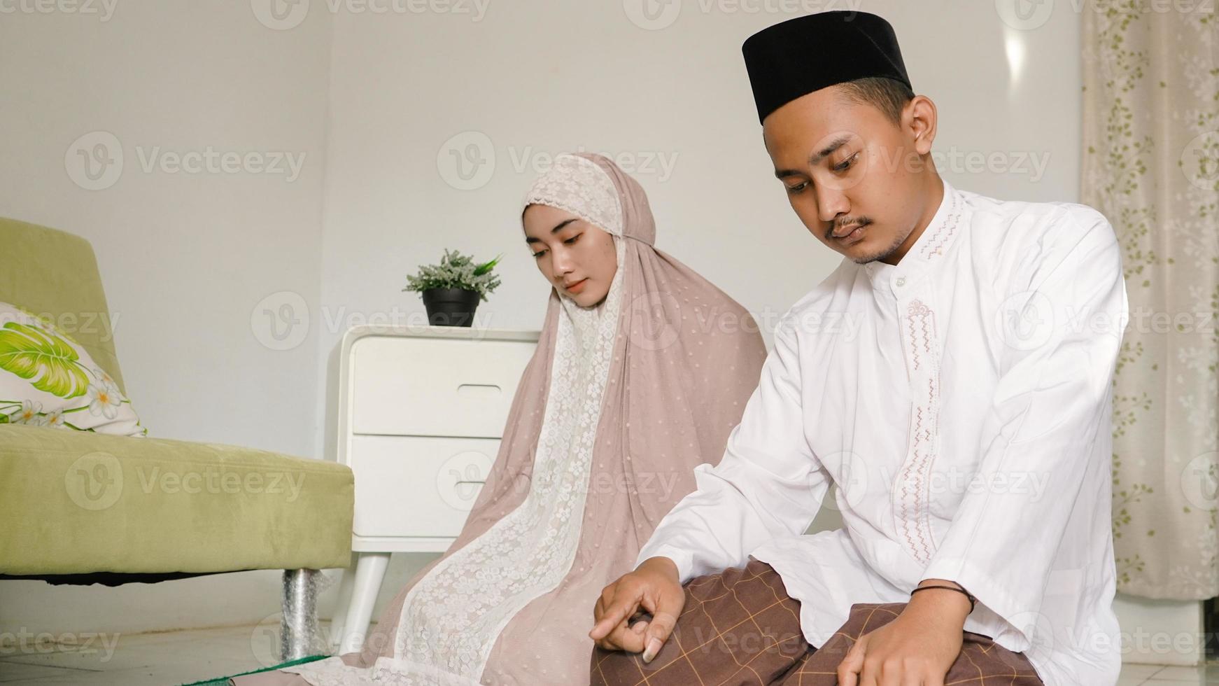 Asian couple praying together at home photo