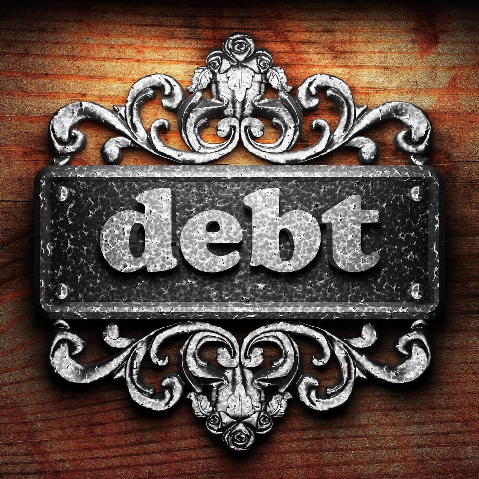 debt word of iron on wooden background photo