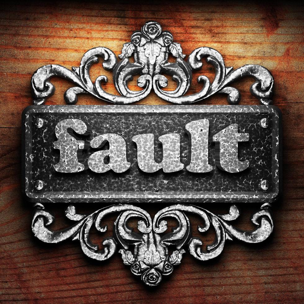 fault word of iron on wooden background photo