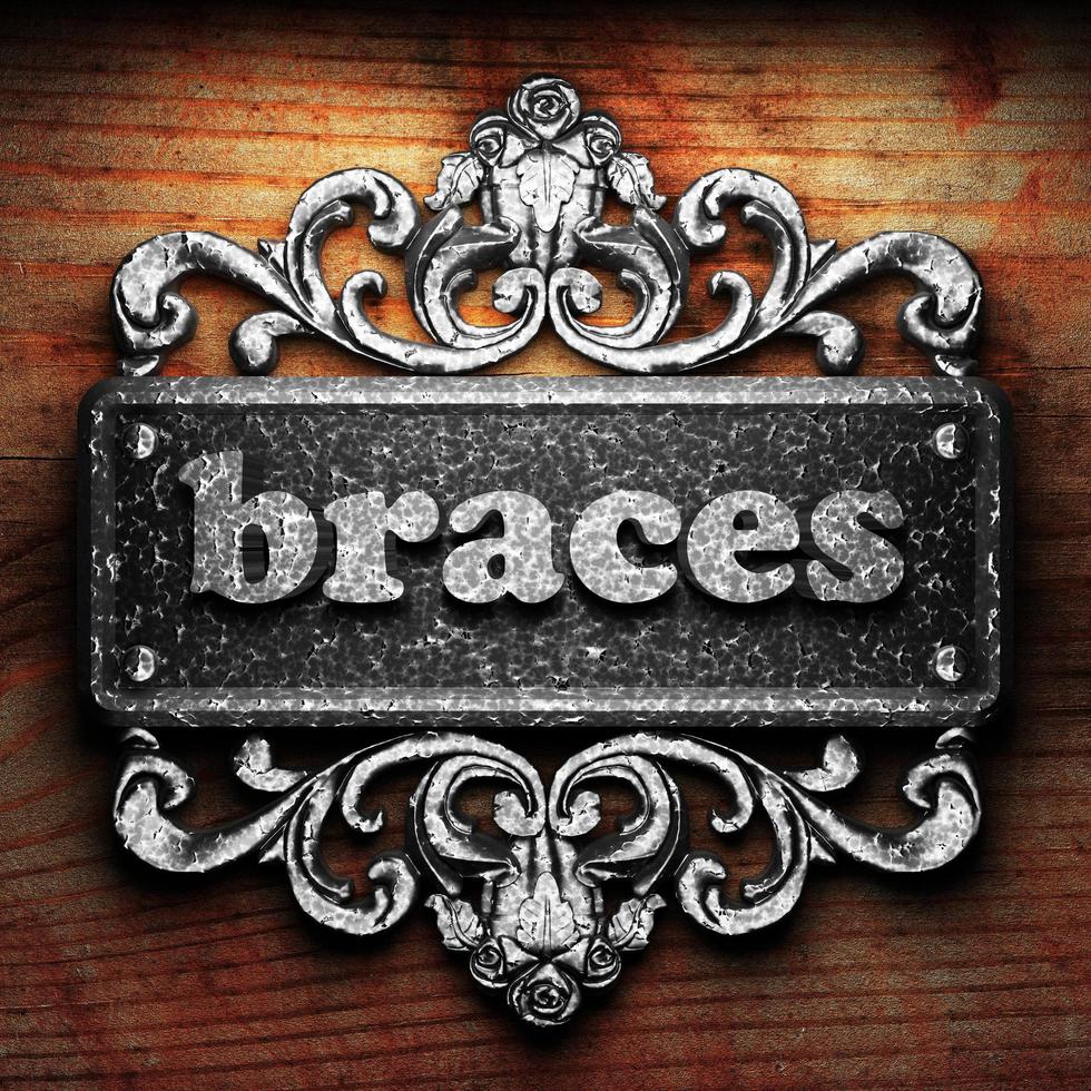 braces word of iron on wooden background photo