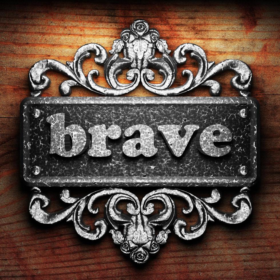 brave word of iron on wooden background photo