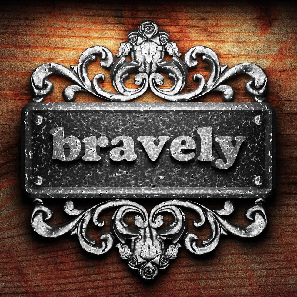 bravely word of iron on wooden background photo