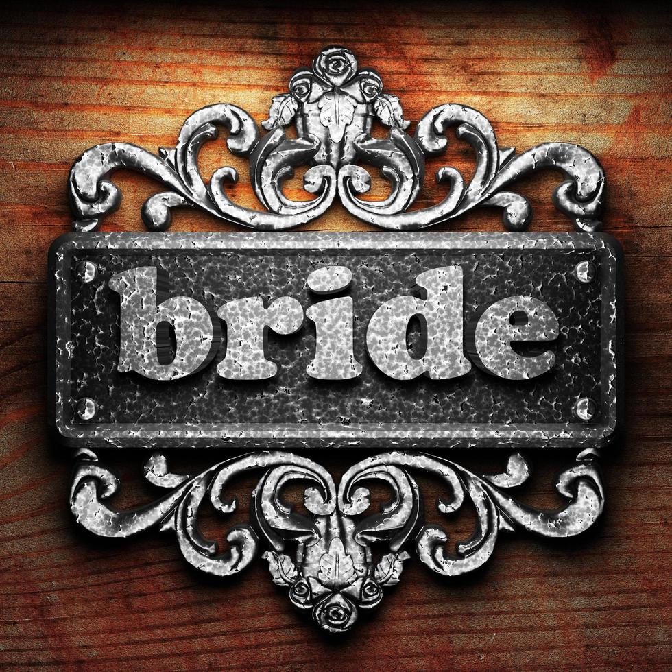 bride word of iron on wooden background photo