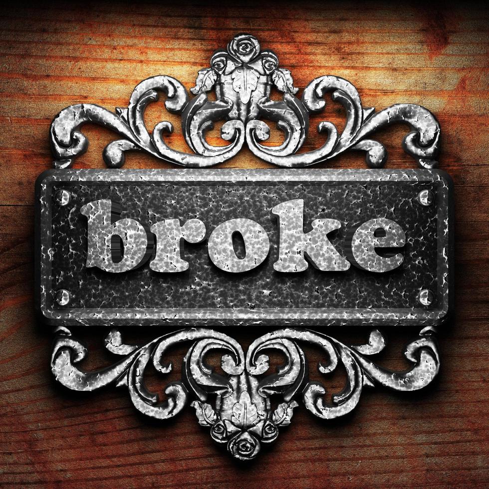 broke word of iron on wooden background photo