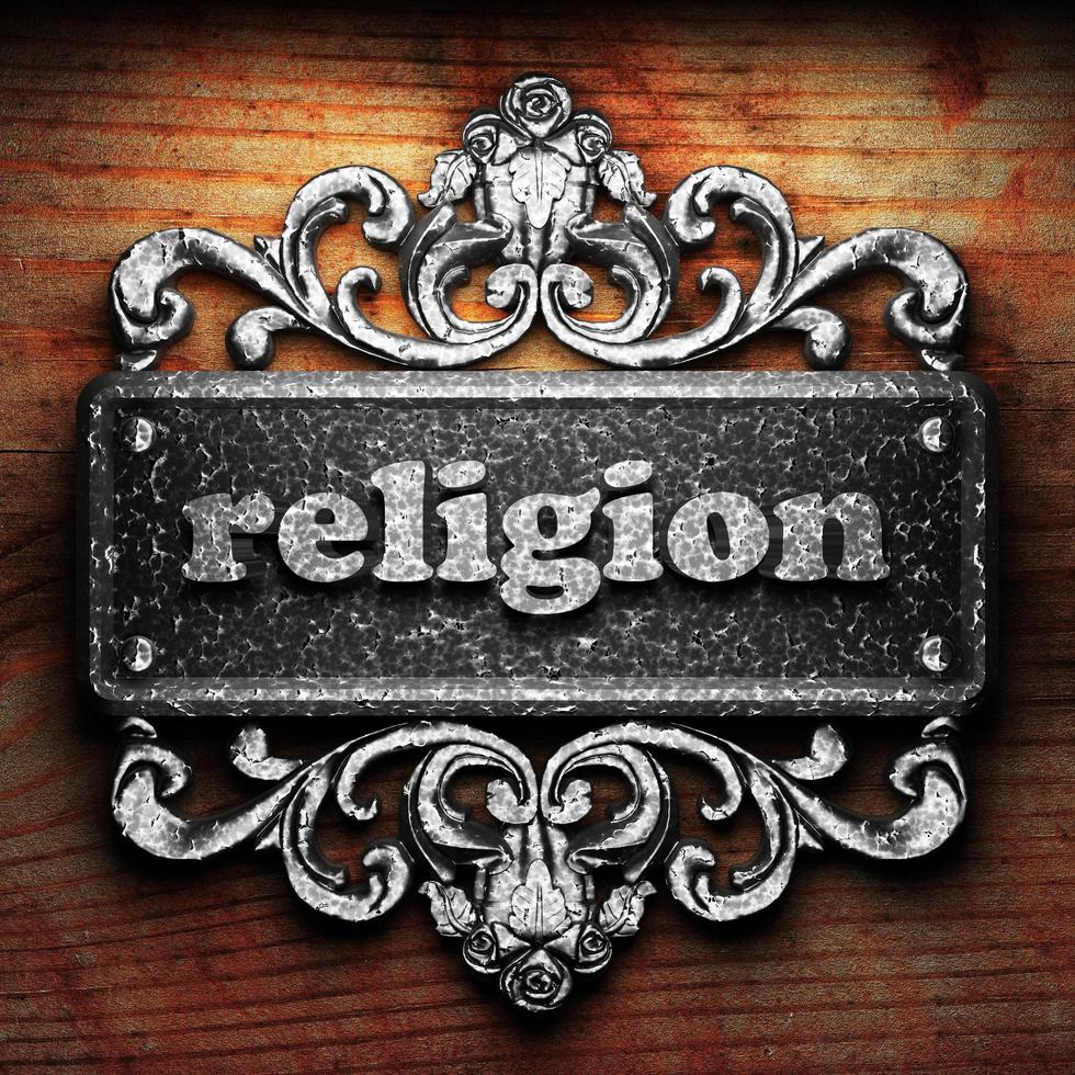 religion word of iron on wooden background photo
