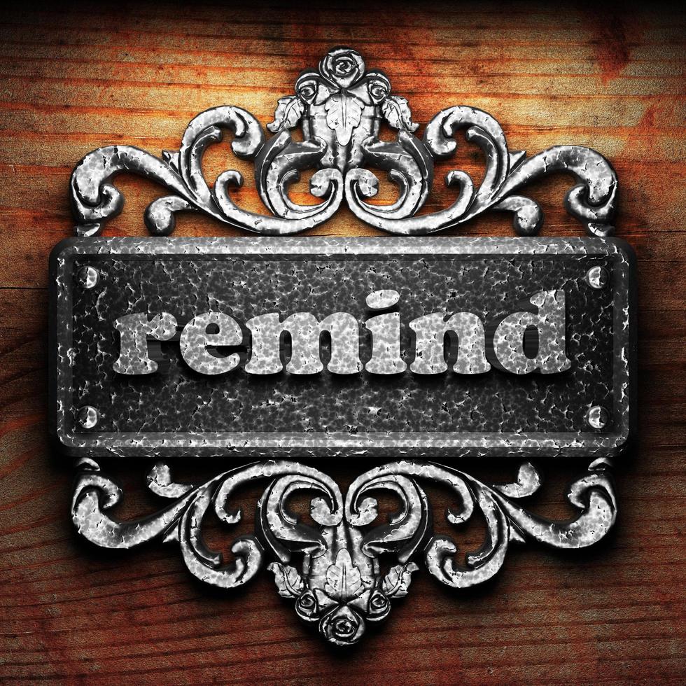 remind word of iron on wooden background photo