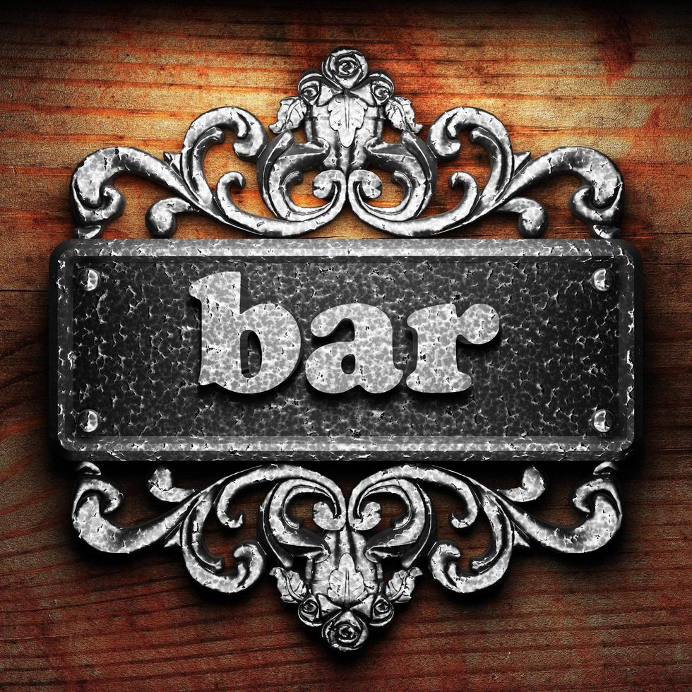 bar word of iron on wooden background photo