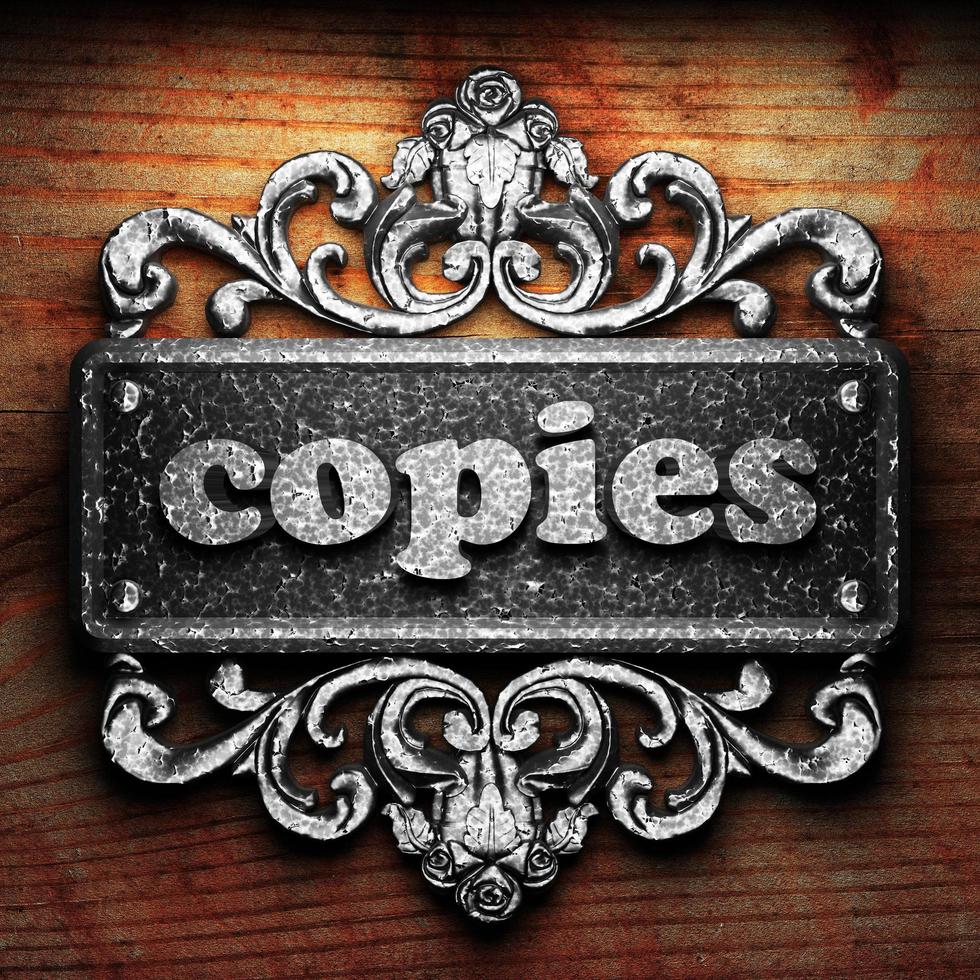 copies word of iron on wooden background photo