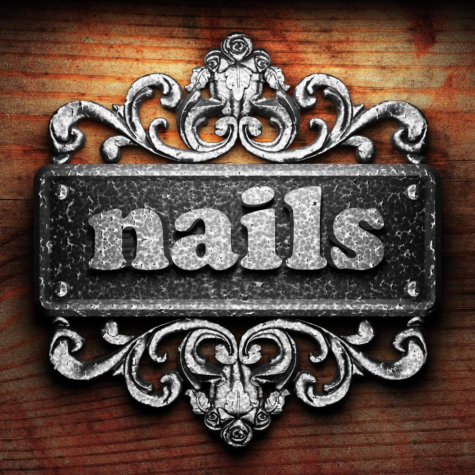 nails word of iron on wooden background photo