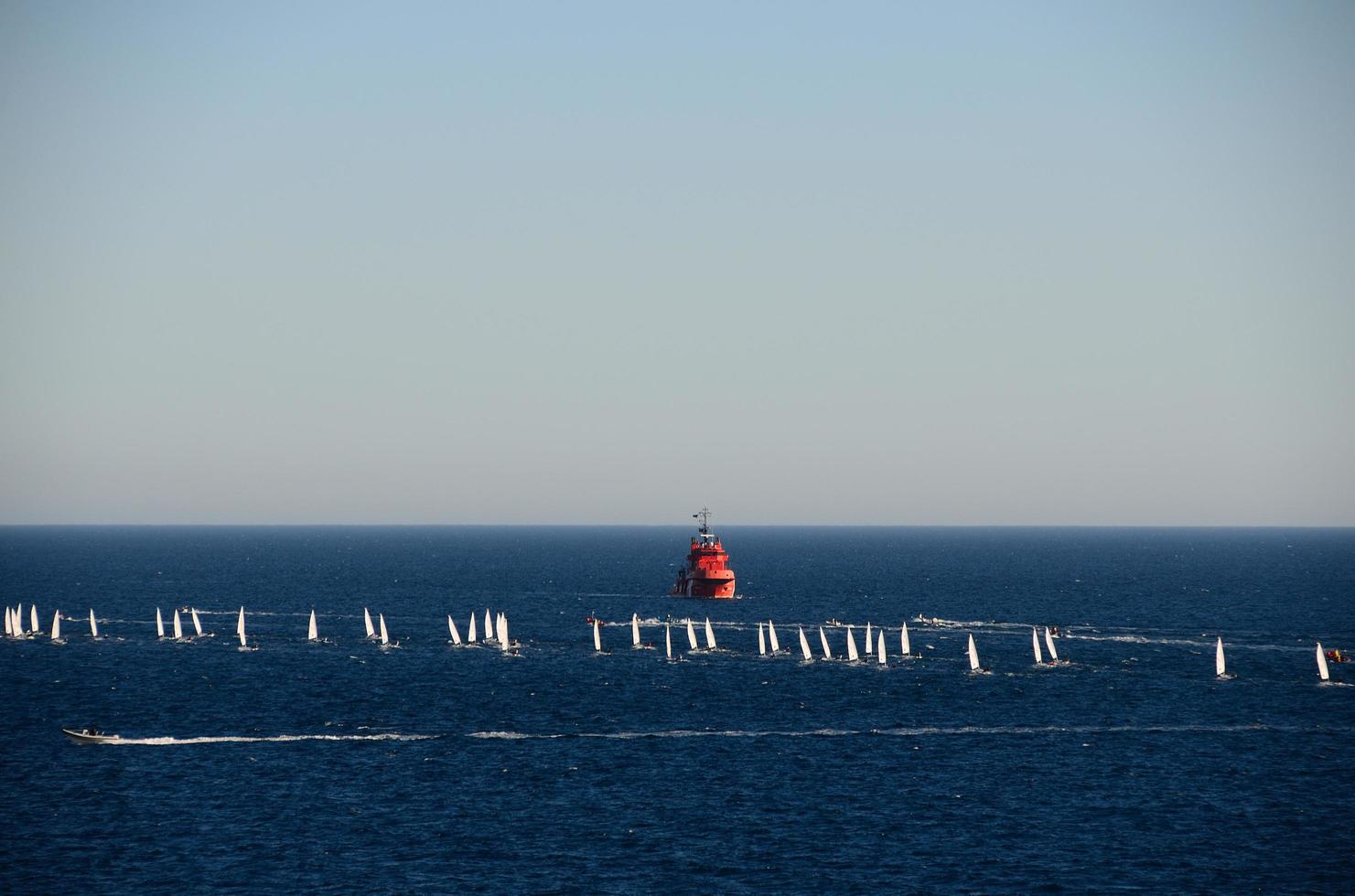 red ship and sailboats photo