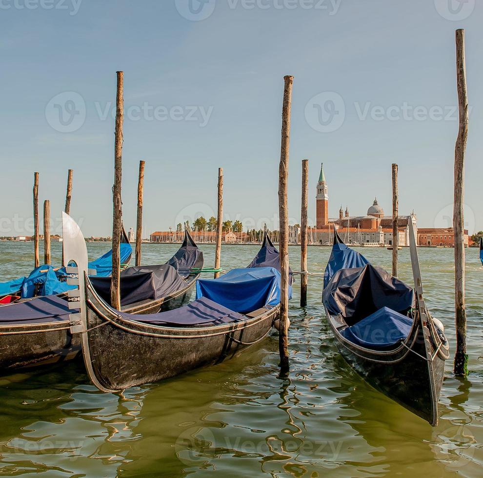 Gondola at jetty with background giudecca in venice photo